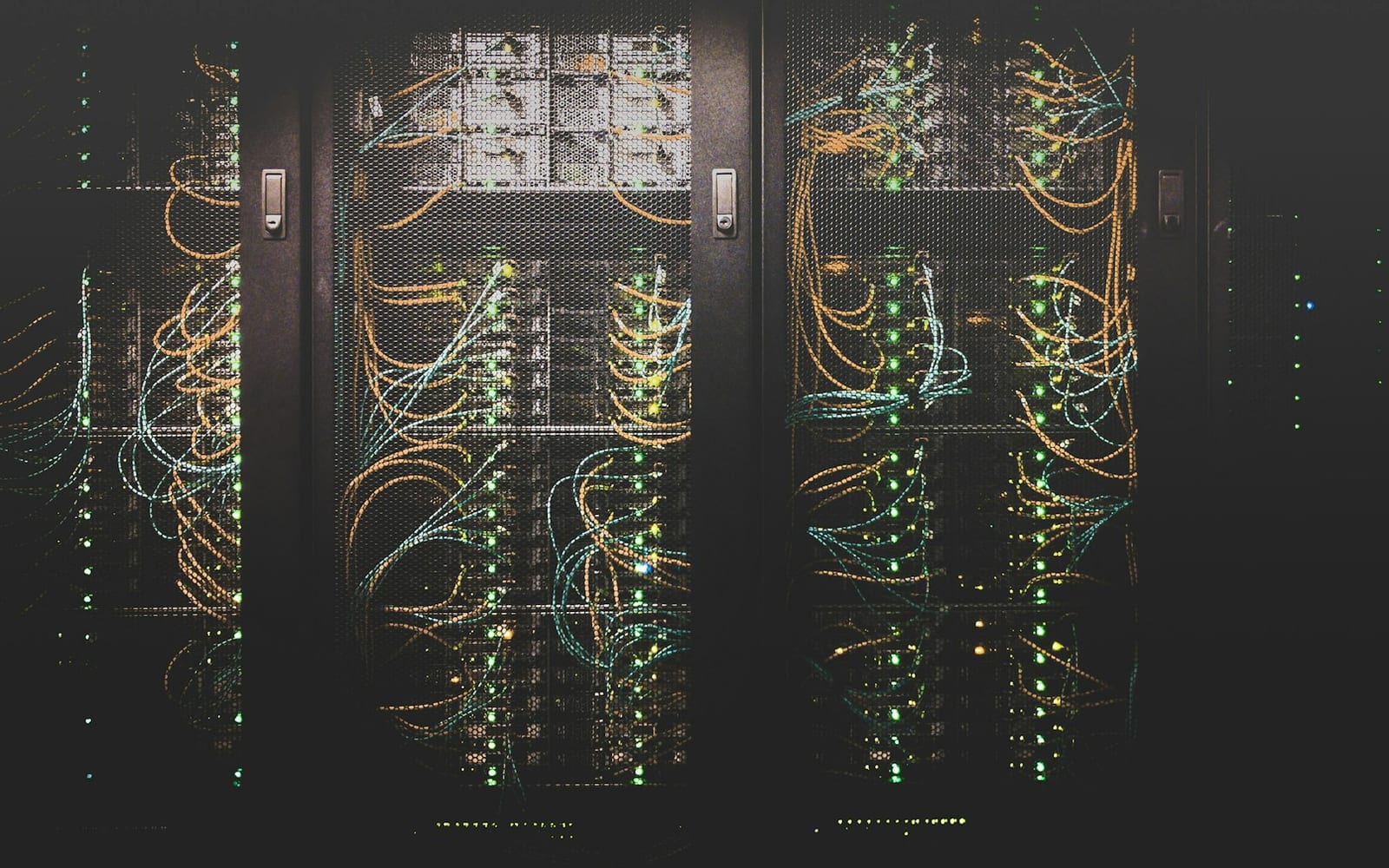 Illuminated server racks along a datacentre aisle